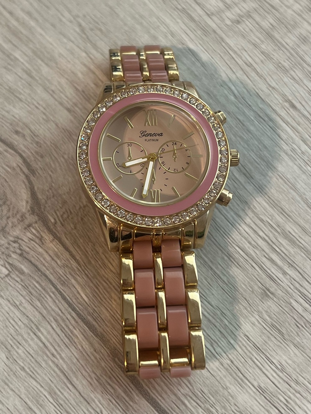 Geneva Gold Tone Watch with Pink Dial and Bracelet Inlays
